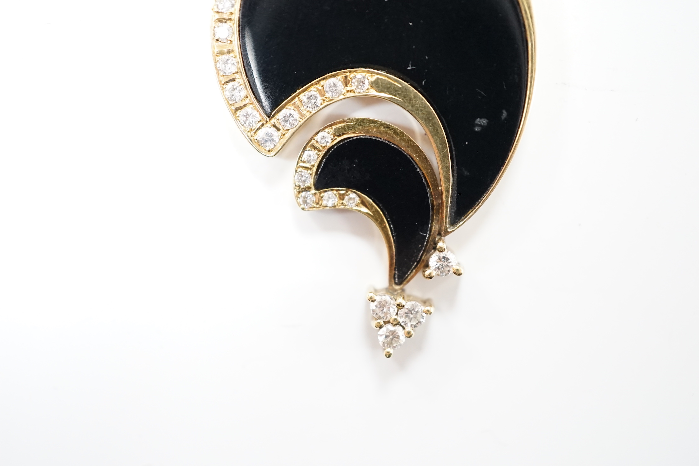 A Hong Kong 585 yellow metal, black onyx and diamond set stylised pendant, 43mm, gross weight 12.1 grams.